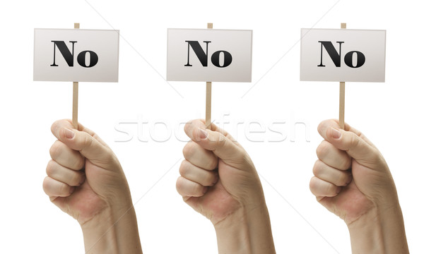 Three Signs In Fists Saying No, No and No Stock photo © feverpitch