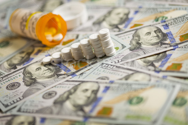 Medicine Pills Stacked on Newly Designed One Hundred Dollar Bill Stock photo © feverpitch