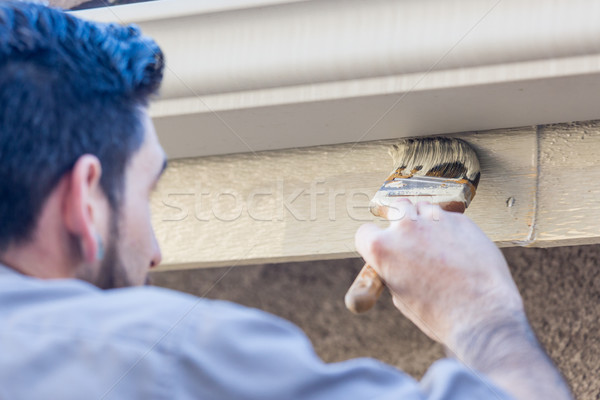 Professional Painter Using Brush to Paint House Fascia Under Rai Stock photo © feverpitch