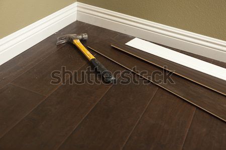 Stock photo: Hammer, Laminate Flooring and New Baseboard Molding