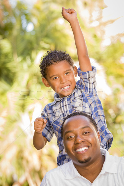 Mixed Race Father and Son Cheering with Fist in Air Stock photo © feverpitch