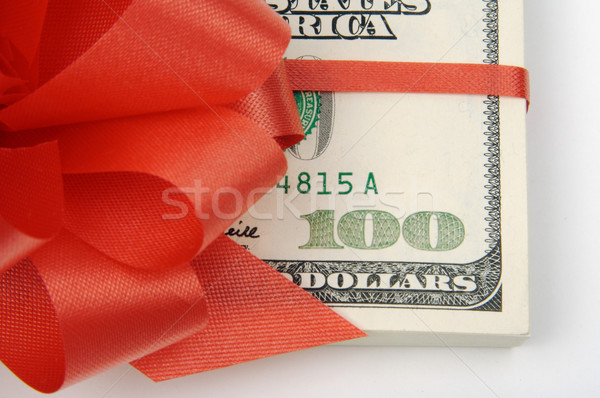 One Hundred Dollar Bills Wrapped in Red Ribbon. Stock photo © feverpitch