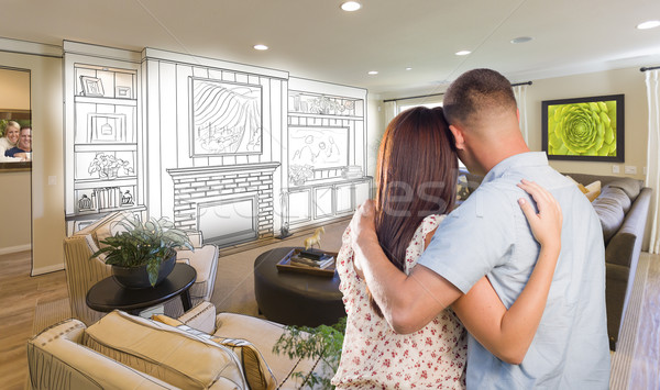 Stock photo: Young Military Couple Inside Custom Room and Design Drawing
