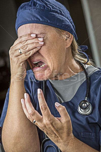 Agonizing Crying Female Doctor or Nurse Stock photo © feverpitch