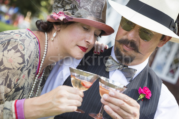 Mixed-Race Couple Dressed in 1920’s Era Fashion Sipping Champagne Stock photo © feverpitch