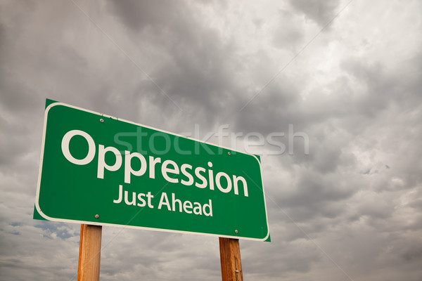 Oppression Green Road Sign Over Storm Clouds Stock photo © feverpitch