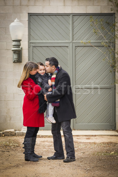Warmly Dressed Family Loving Son in Front of Rustic Building Stock photo © feverpitch