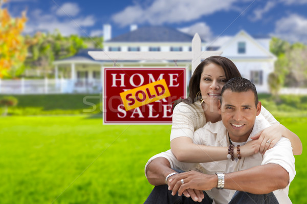 Hispanic Couple, New Home and Sold Real Estate Sign Stock photo © feverpitch