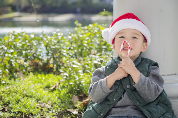 Cute Mixed Race Boy With Santa Hat and Candy Cane Stock photo © feverpitch