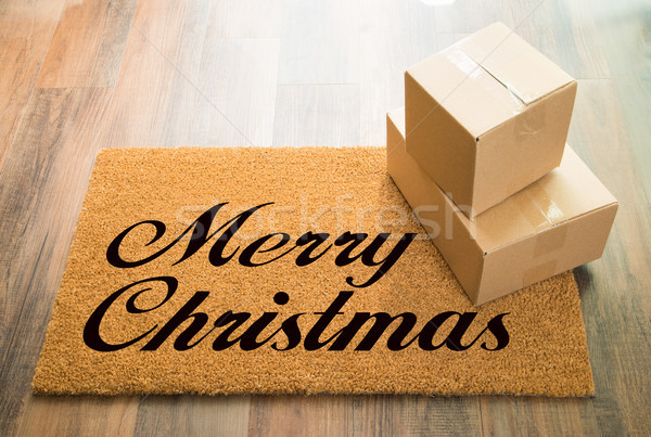 Merry Christmas Welcome Mat On Wood Floor With Shipment of Boxes Stock photo © feverpitch
