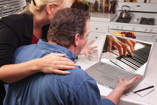 Couple In Kitchen Using Laptop - Music Performance Stock photo © feverpitch