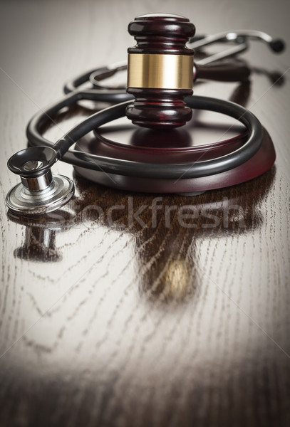 Stock photo: Gavel and Stethoscope on Reflective Table