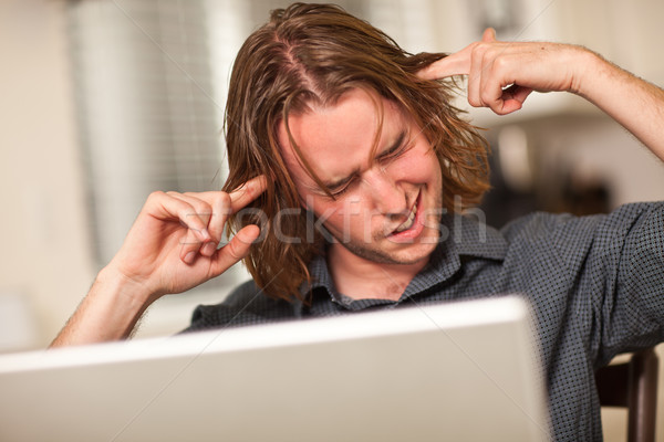 Young Man Getting Loopy While Using Laptop Computer Stock photo © feverpitch