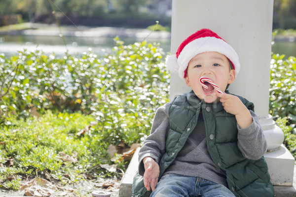 Cute Mixed Race Boy With Santa Hat and Candy Cane Stock photo © feverpitch