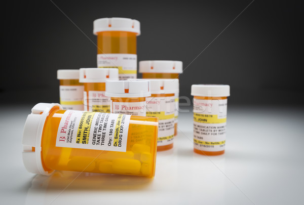 Medicine Bottles on Reflective Surface and Grey Background Stock photo © feverpitch
