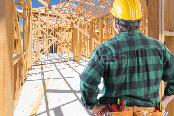 Contractor Standing Inside Construction Framing of New House. Stock photo © feverpitch