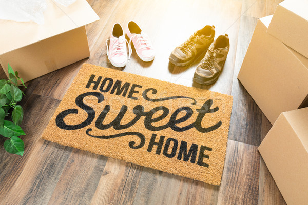 Home Sweet Home Welcome Mat, Moving Boxes, Women and Male Shoes  Stock photo © feverpitch