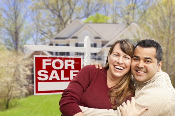 Stock photo: Couple in Front of For Sale Sign and House
