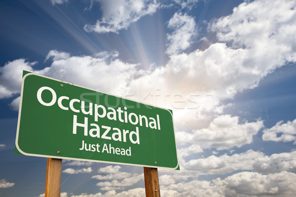 Occupational Hazard Green Road Sign Over Clouds Stock photo © feverpitch