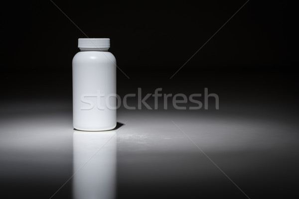 Blank White Bottle Ready For Your Text Under Spot Light. Stock photo © feverpitch