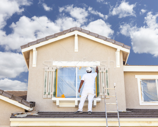 House Painter Painting the Trim And Shutters of Home Stock photo © feverpitch