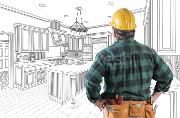 Male Contractor with Hard Hat and Tool Belt Looking At Custom Ki Stock photo © feverpitch