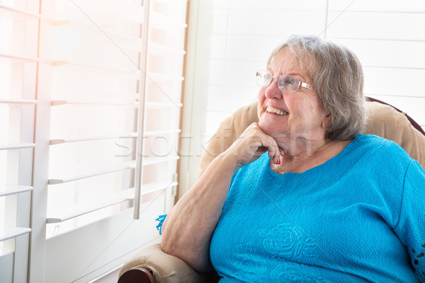 Zawartość starszy kobieta na zewnątrz okno domu Zdjęcia stock © feverpitch