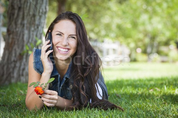 Félvér fiatal női beszél mobiltelefon kívül Stock fotó © feverpitch