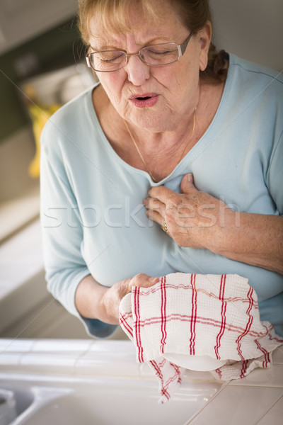 Senior Adult Woman At Sink With Chest Pains Stock photo © feverpitch