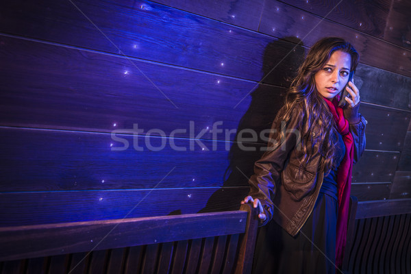 Frightened Young Woman in Dark Walkway Using Cell Phone Stock photo © feverpitch