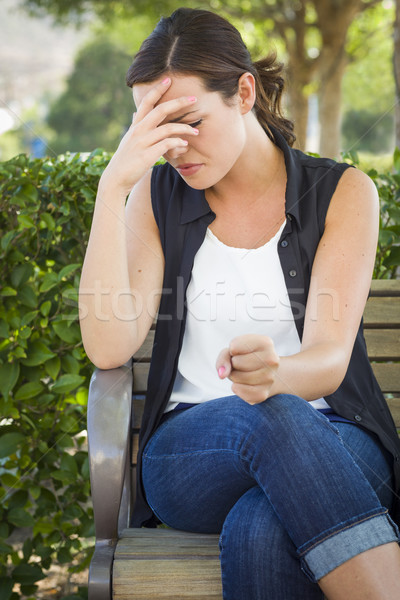 Upset Young Woman Sitting Alone on Bench Stock photo © feverpitch