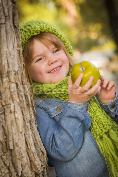 Young Girl Wearing Green Scarf and Hat Eating Apple Outside Stock photo © feverpitch