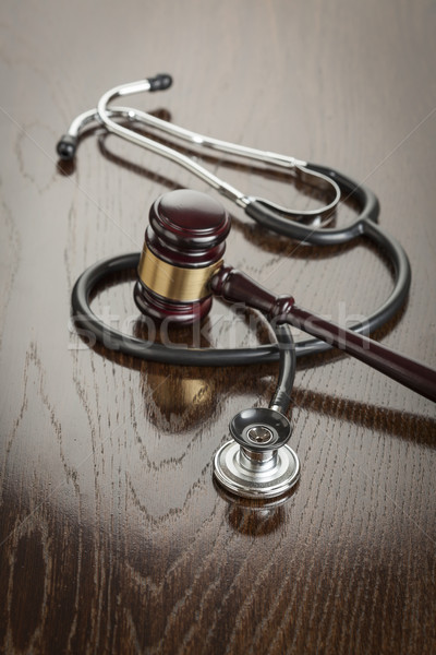 Stock photo: Gavel and Stethoscope on Reflective Table