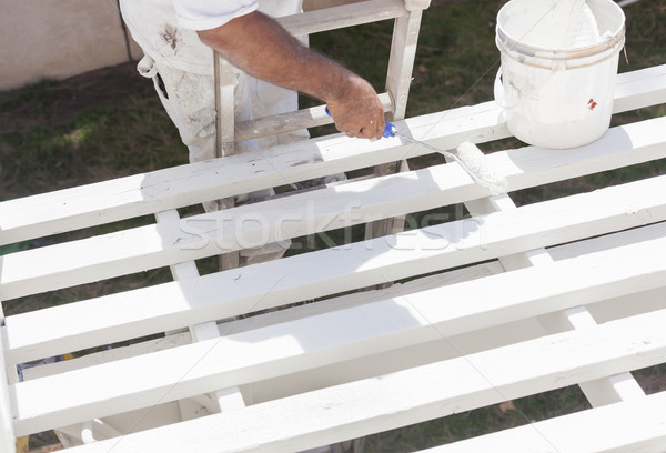 Painter Rolling White Paint Onto Top of Patio Cover Stock photo © feverpitch