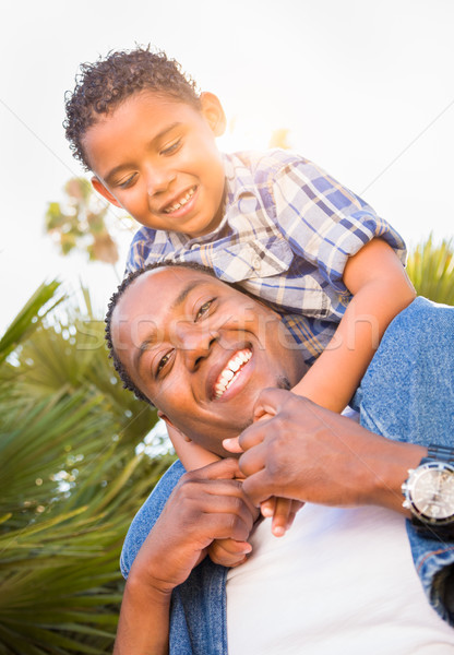 Mixed Race Son and African American Father Playing Piggyback Out Stock photo © feverpitch