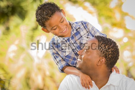 Mixed Race Father and Son Playing with Paper Airplanes Stock photo © feverpitch