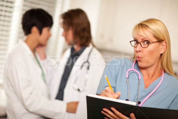 Alarmed Medical Woman Witnesses Colleagues Inner Office Romance Stock photo © feverpitch