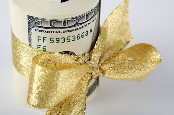 One Hundred Dollar Bills Wrapped in Gold Ribbon. Stock photo © feverpitch