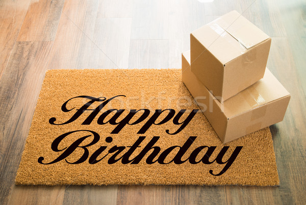 Happy Birthday Welcome Mat On Wood Floor With Shipment of Boxes Stock photo © feverpitch