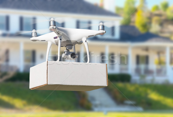 Unmanned Aircraft System (UAV) Quadcopter Drone Delivering Packa Stock photo © feverpitch