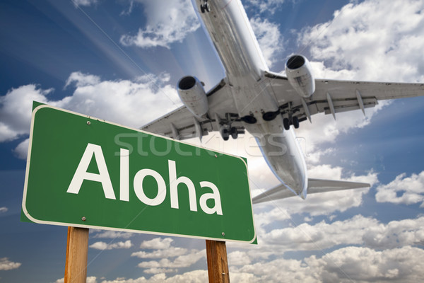 Aloha Green Road Sign and Airplane Above Stock photo © feverpitch