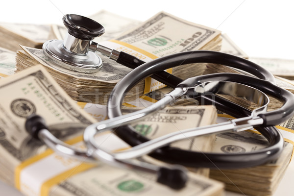 Stethoscope Laying on Stacks of Money Stock photo © feverpitch