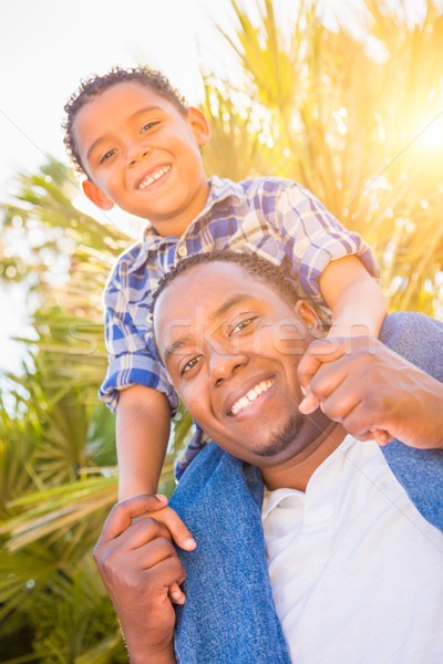 Mixed Race Son and African American Father Playing Piggyback Out Stock photo © feverpitch