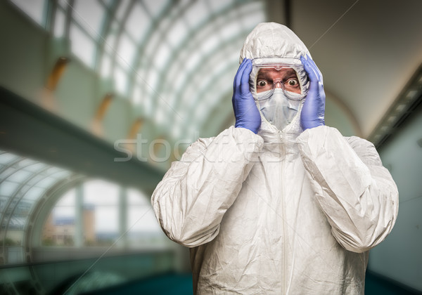 Stock photo: Man Holding Head With Hands Wearing HAZMAT Protective Clothing I