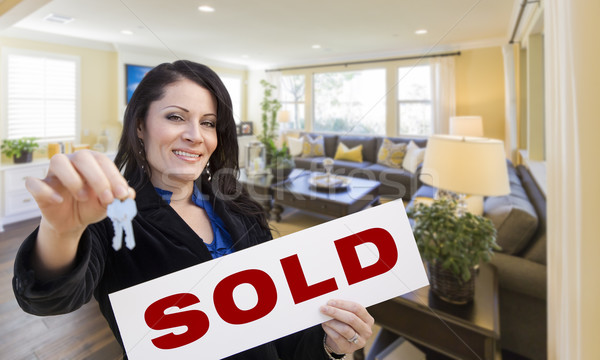 Hispanic Woman with Keys and Sold Sign in Living Room Stock photo © feverpitch