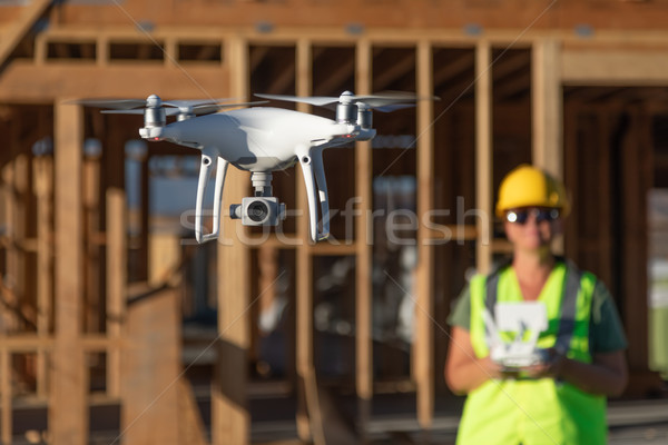 Female Pilot Flies Drone Quadcopter Inspecting Construction Site Stock photo © feverpitch
