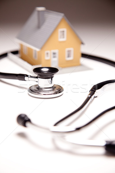 Stethoscope and Model House on Gradated Background Stock photo © feverpitch