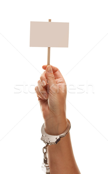 Handcuffed Woman Holding Blank White Sign Isolated on White Stock photo © feverpitch