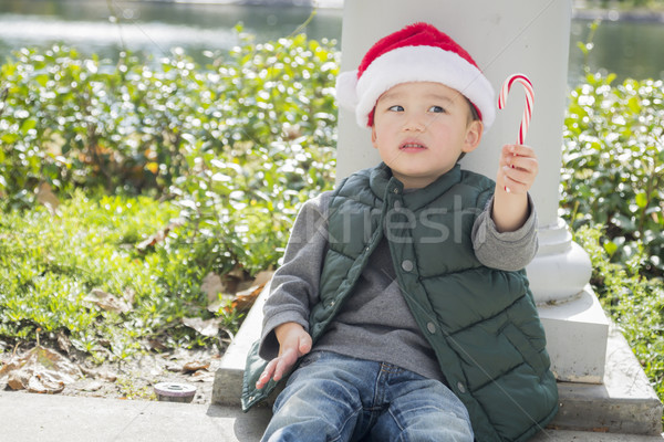 Cute Mixed Race Boy With Santa Hat and Candy Cane Stock photo © feverpitch