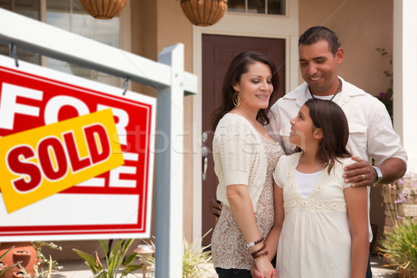 Hispanic Family in Front of Their New Home with Sold Sign Stock photo © feverpitch